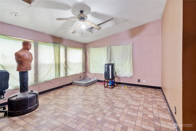 exercise room with ceiling fan