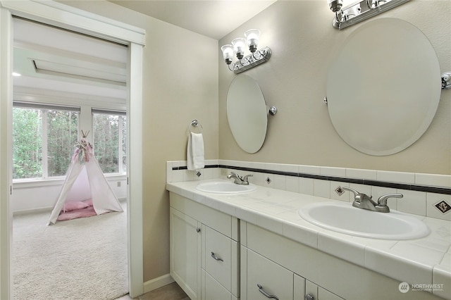 bathroom with vanity and tasteful backsplash