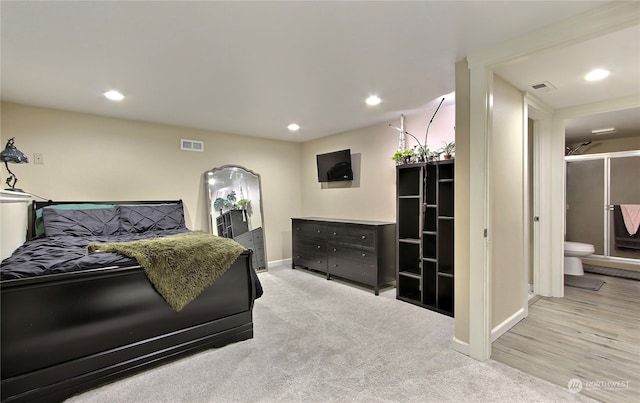 carpeted bedroom with ensuite bath