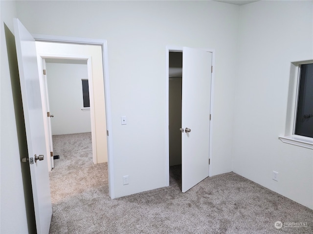 unfurnished bedroom with light colored carpet