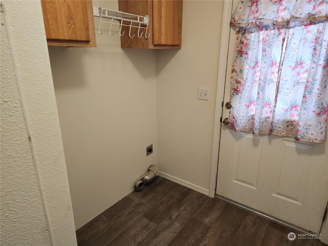 laundry area with cabinets, electric dryer hookup, and dark wood-type flooring