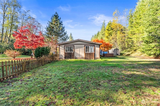 view of yard featuring an outbuilding and a wooden deck