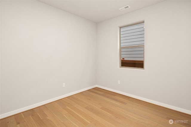 empty room with light hardwood / wood-style flooring