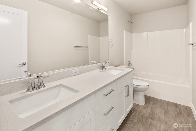 full bathroom featuring bathing tub / shower combination, toilet, and vanity