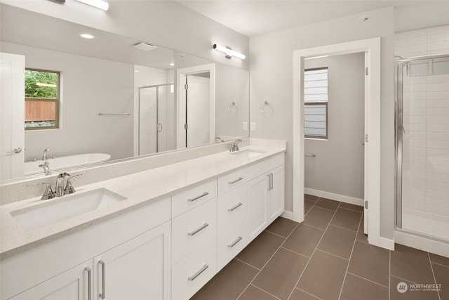 bathroom featuring a shower with door, tile patterned flooring, and vanity