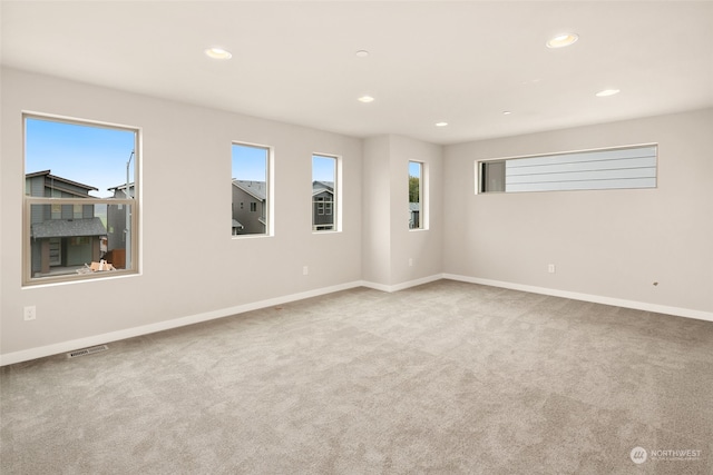 unfurnished room featuring light colored carpet