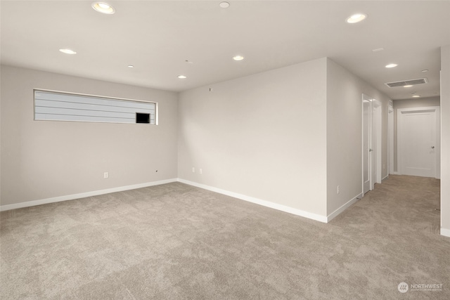 unfurnished room with light carpet