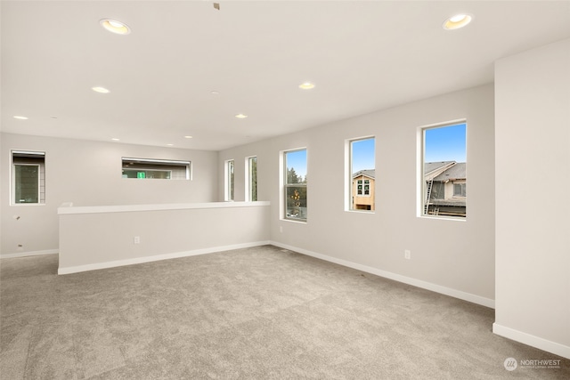 unfurnished living room featuring light carpet