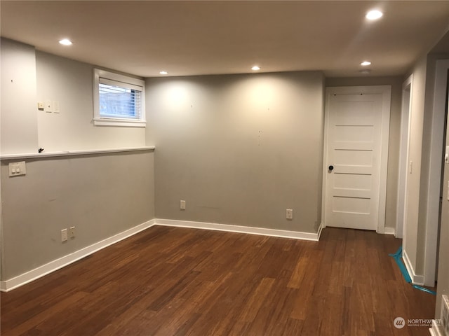 basement with dark hardwood / wood-style floors