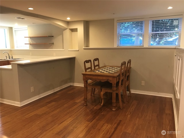 dining area with dark wood-type flooring and sink