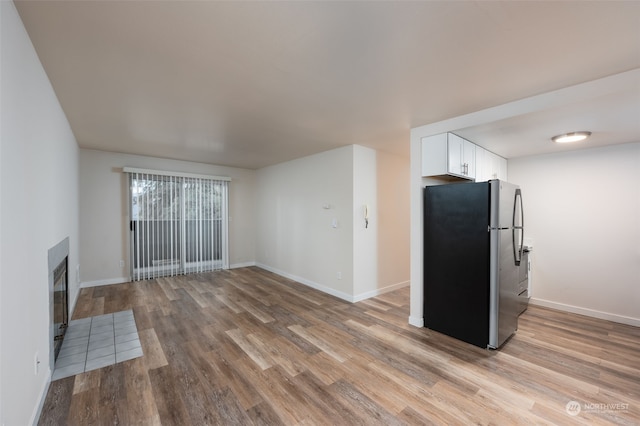 unfurnished living room with light hardwood / wood-style flooring