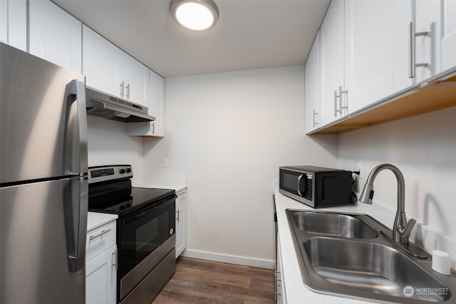 kitchen featuring stainless steel appliances, white cabinetry, sink, and dark hardwood / wood-style flooring