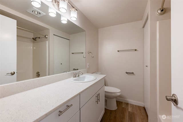 bathroom featuring hardwood / wood-style floors, vanity, and toilet