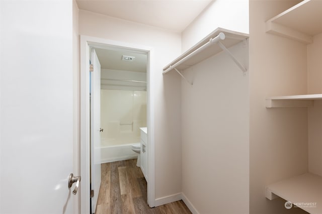 spacious closet featuring light hardwood / wood-style floors