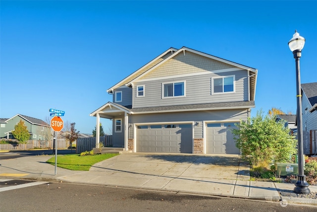 view of front of house featuring a garage and a front lawn