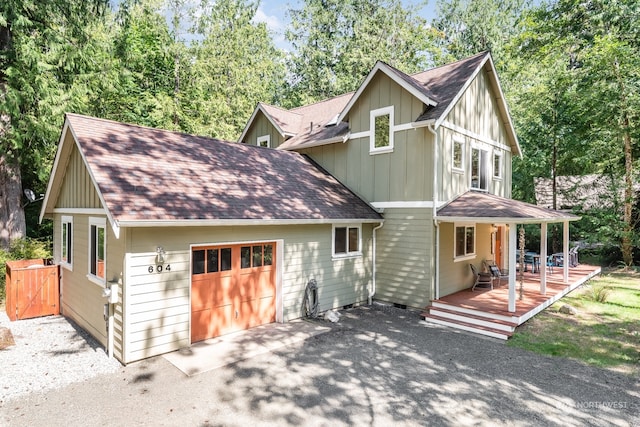 view of front of house featuring a garage and a wooden deck