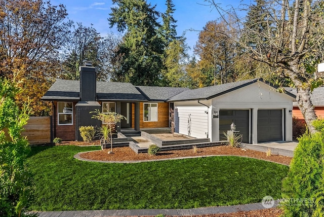 ranch-style home featuring a garage and a front lawn