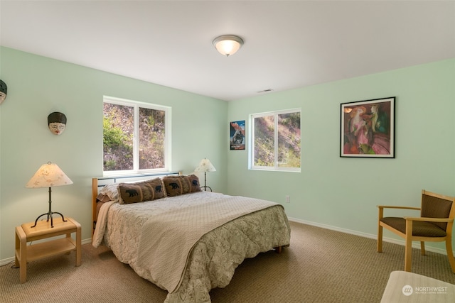 bedroom featuring light carpet