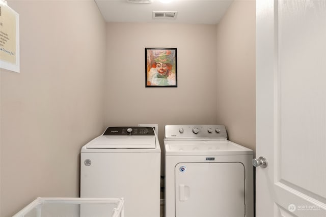 washroom with independent washer and dryer