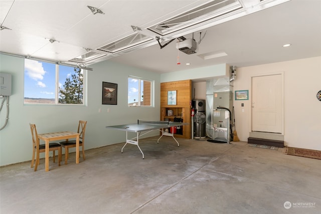 garage with water heater and a garage door opener