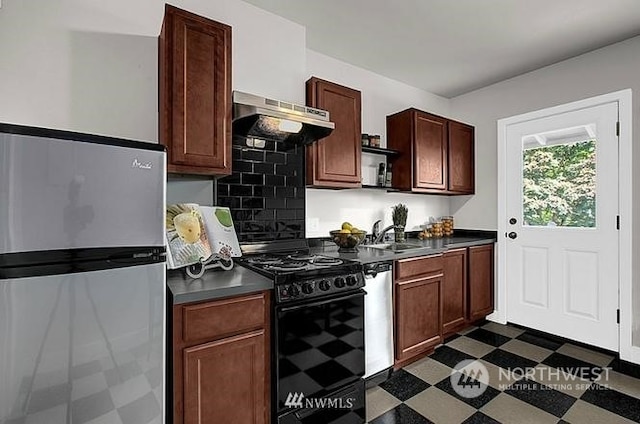 kitchen with decorative backsplash, appliances with stainless steel finishes, sink, and exhaust hood