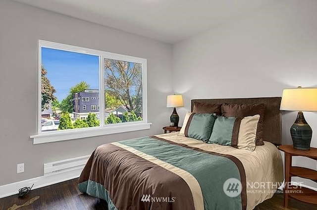 bedroom with dark hardwood / wood-style flooring