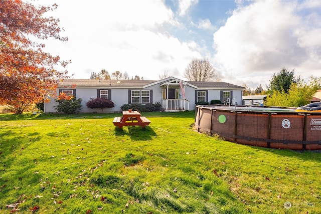 rear view of house with a yard