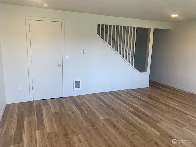 unfurnished room featuring hardwood / wood-style flooring