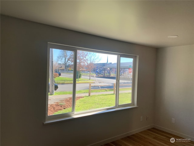 unfurnished room featuring hardwood / wood-style flooring and plenty of natural light