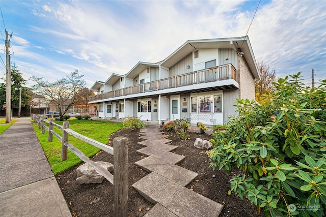 view of front of house with covered porch and a balcony