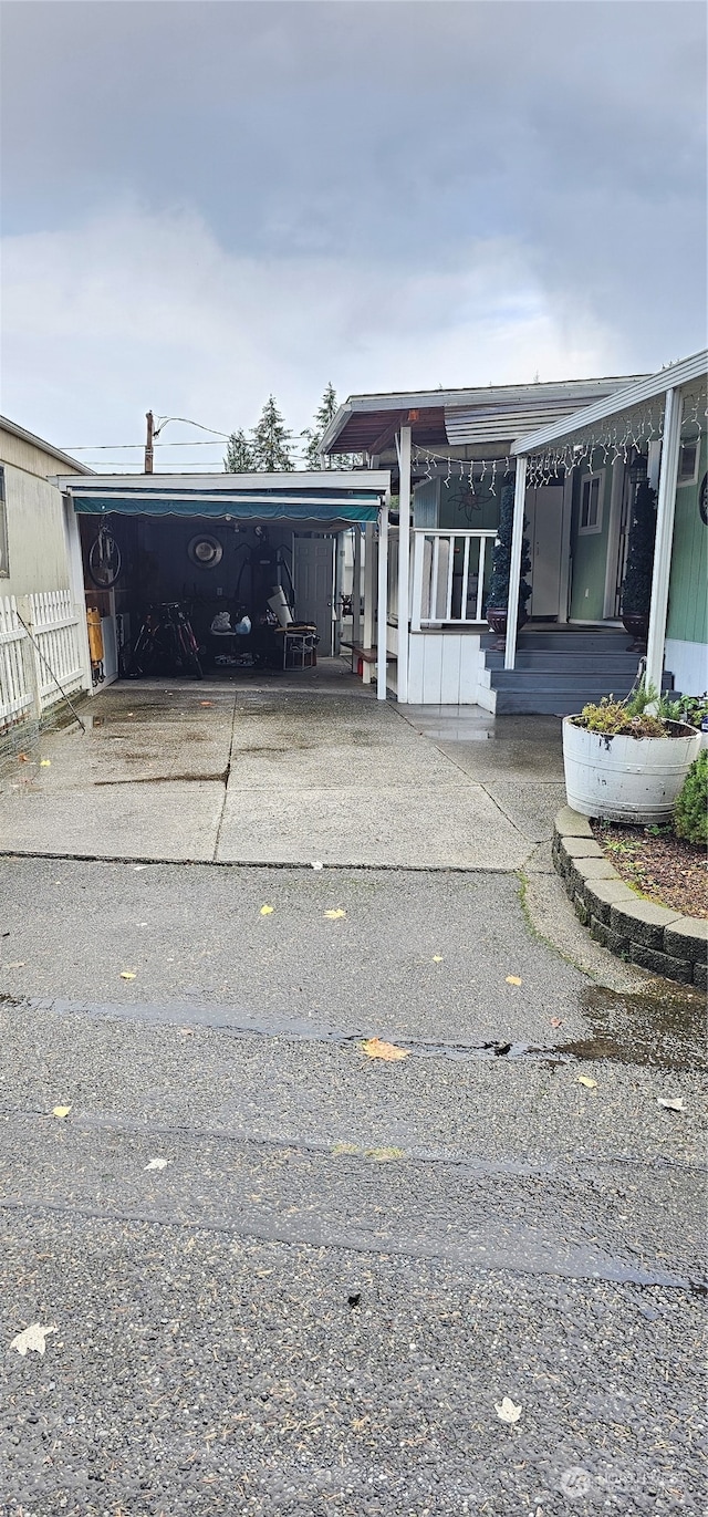 view of front of property with covered porch and a carport