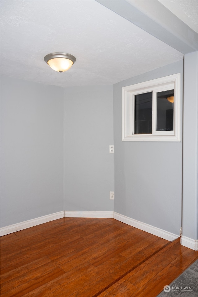 spare room featuring wood-type flooring