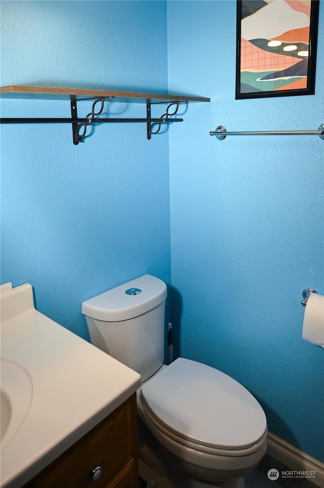 bathroom featuring toilet and vanity