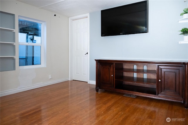 unfurnished living room with hardwood / wood-style floors