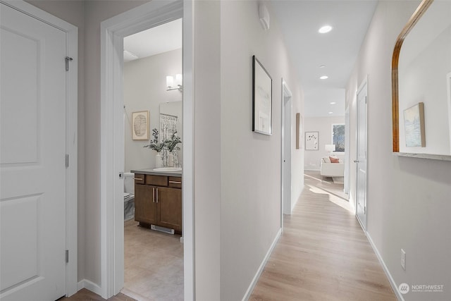 corridor with light hardwood / wood-style floors