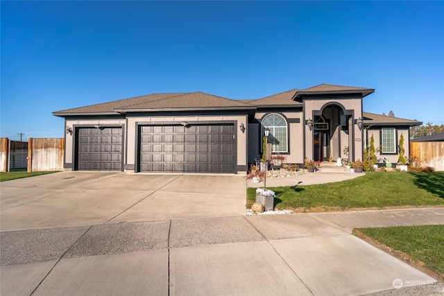 view of front of property featuring a garage and a front lawn