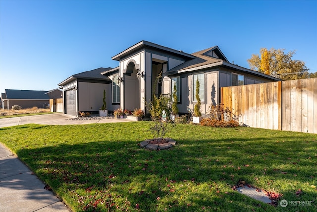 view of front of home featuring a garage and a front yard