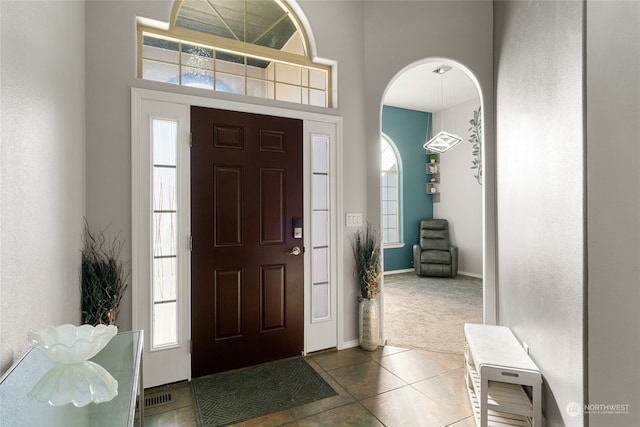 tiled foyer entrance with a wealth of natural light