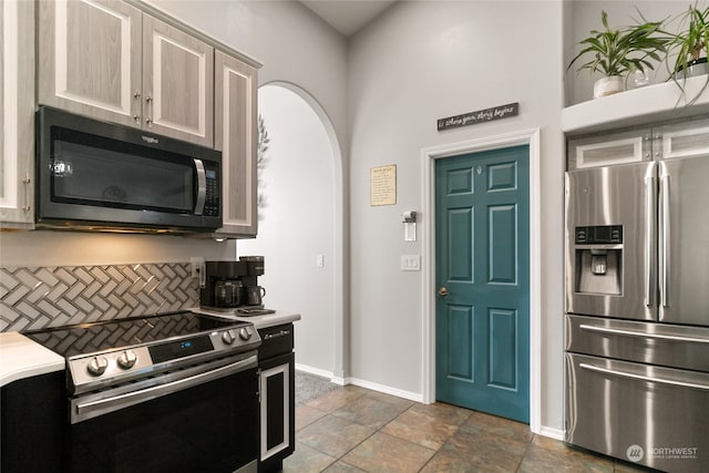 kitchen with appliances with stainless steel finishes and tasteful backsplash