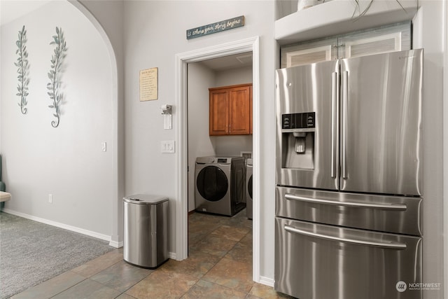 laundry room with cabinets, independent washer and dryer, and carpet