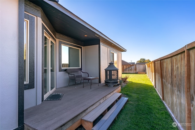 wooden terrace with a yard