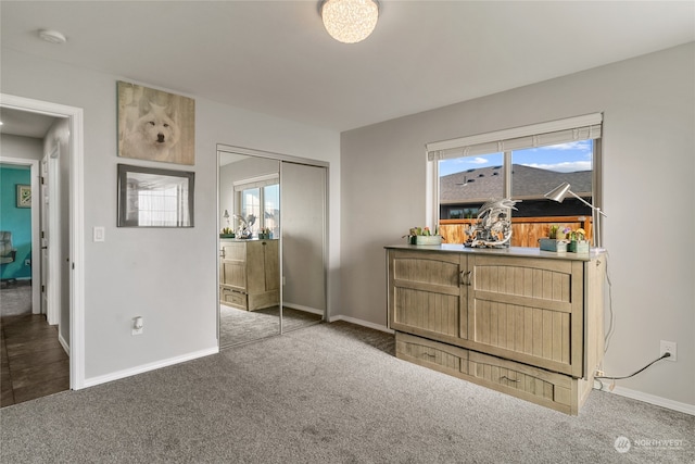 bedroom featuring a closet and dark colored carpet