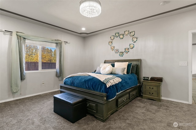 carpeted bedroom featuring an inviting chandelier