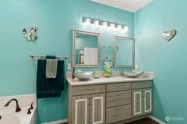 bathroom with vanity and a washtub