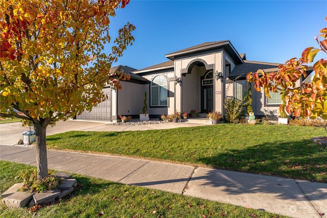 view of front of home with a garage and a front yard