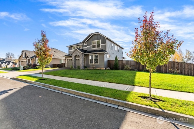 view of front of property with a garage and a front yard