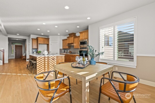 dining space featuring light wood-type flooring