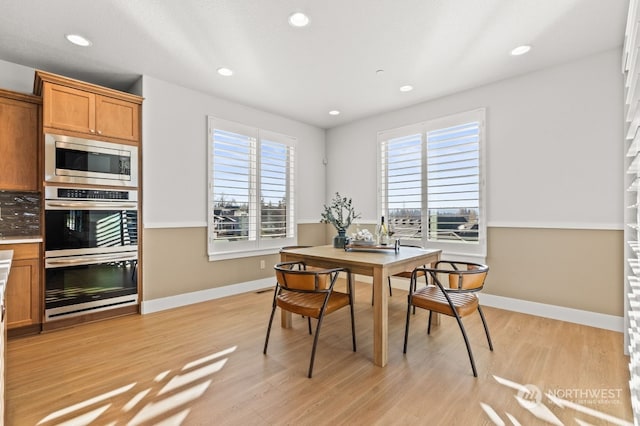 dining area featuring plenty of natural light and light hardwood / wood-style flooring