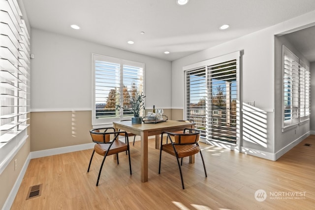 dining area with light hardwood / wood-style flooring