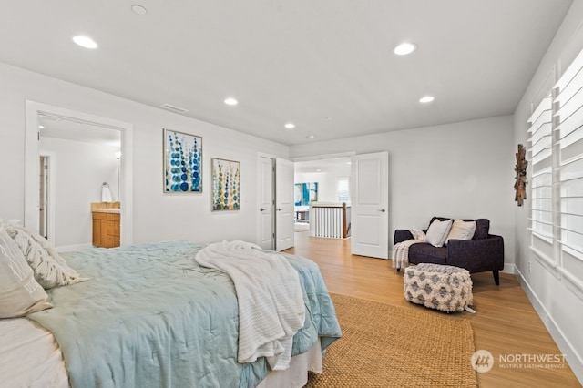 bedroom featuring hardwood / wood-style floors and ensuite bath